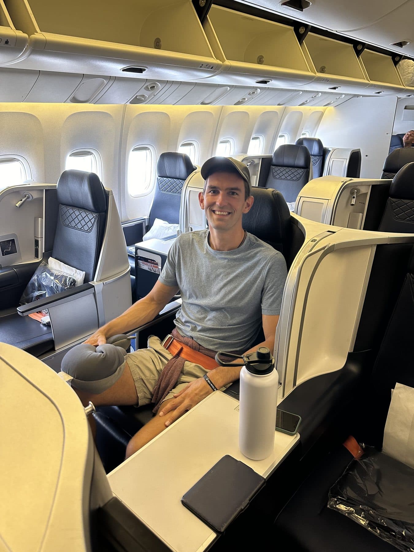 Jon Miksis seated in a lie-flat business-class seat on an Azores Airlines flight from Boston